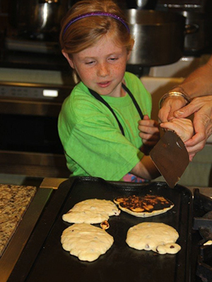 Ella Riddle makes pancakes