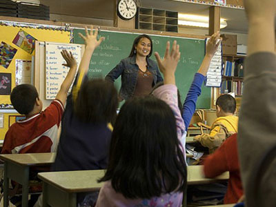 Classroom-teacher-raised-hands-school-By-www.audio-luci.it-on-Flickr-620x350