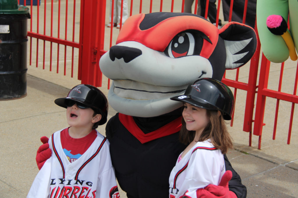 Flying squirrel mascot posing with kids