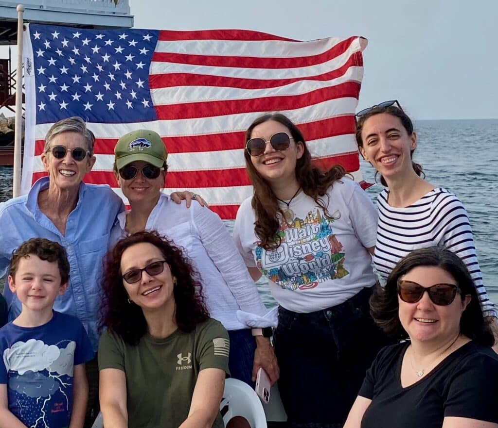 ASO staff on a boat by lighthouse in Chesapeake Bay.